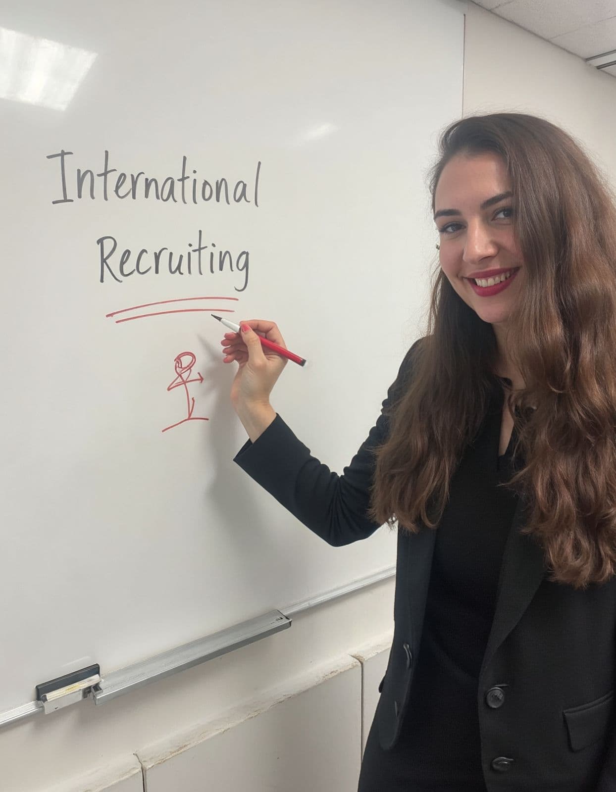 Jana Affum at a whiteboard sketching international recruiting