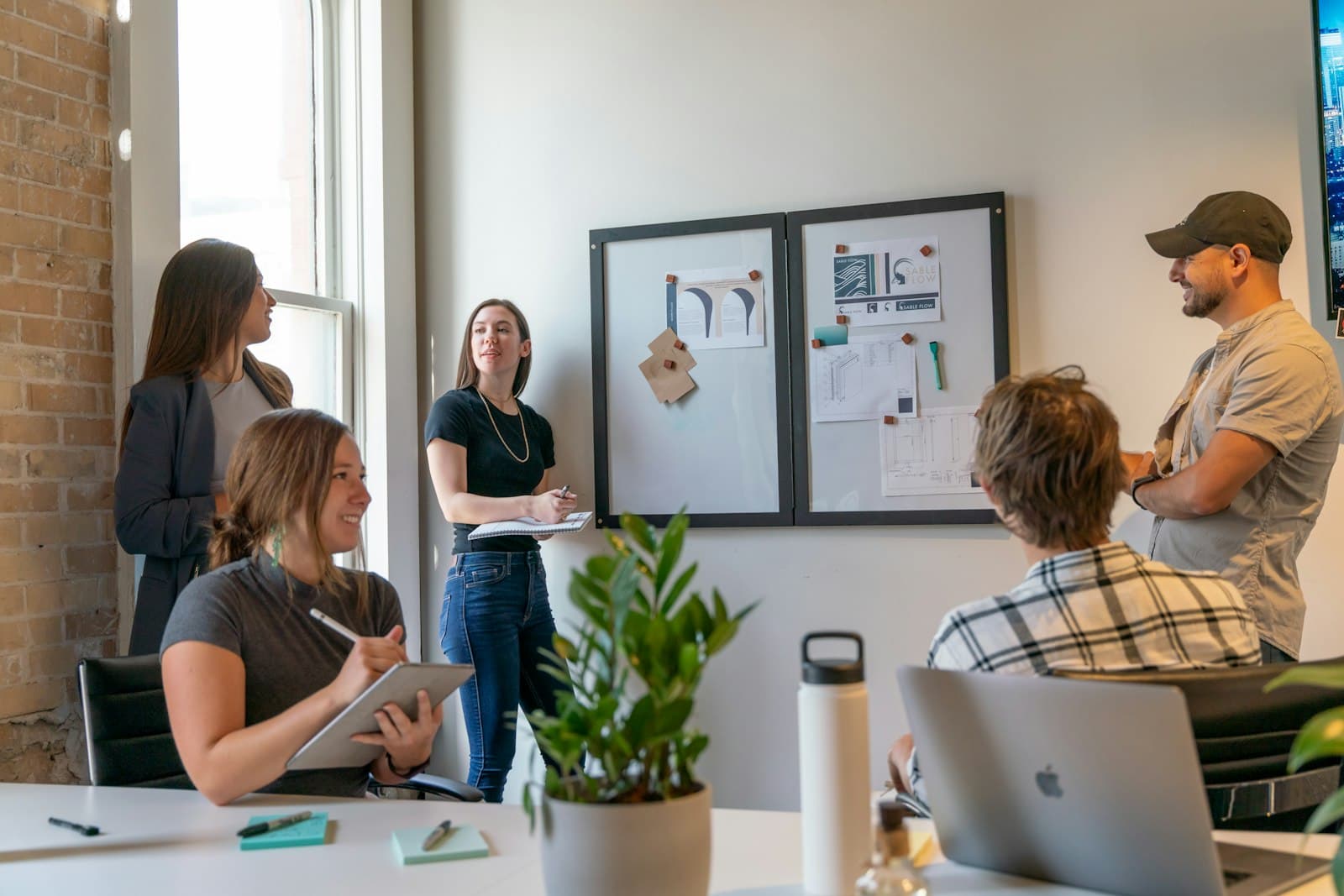 A new team settling in around a sunlit office workspace